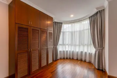 a walk in closet with a large window and wooden floors at 325 Ritchie by COBNB at Ampang in Kuala Lumpur
