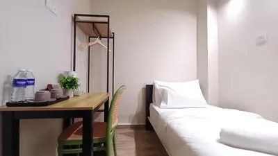 a room with a bed and a table with a bed gmaxwell gmaxwell gmaxwell at Swing and Pillows - ICC Pudu Kuala Lumpur in Kuala Lumpur