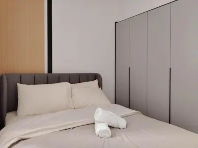 a bed with a white towel on top of it at M Vertica Elegant Stay in Cheras in Kuala Lumpur