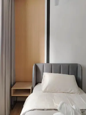 a bed with a gray headboard in a bedroom at M Vertica Elegant Stay in Cheras in Kuala Lumpur