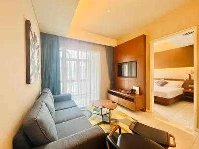 a living room with a couch and a bedroom at Tribeca Homestay Bukit Bintang TRX in Kuala Lumpur