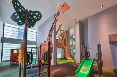 a childrens play room with a playground with a slide at Tribeca Homestay Bukit Bintang TRX in Kuala Lumpur