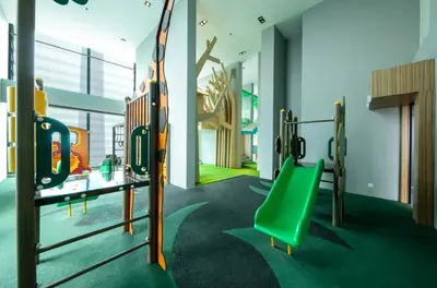 a gym with a green bench and a slide at Tribeca Homestay Bukit Bintang TRX in Kuala Lumpur