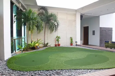 a golf course in the middle of a house at Tribeca Homestay Bukit Bintang TRX in Kuala Lumpur