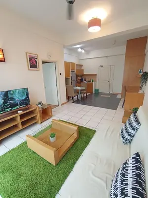a living room with a couch and a tv at Grand suites at Seri Bukit Ceylon in Kuala Lumpur
