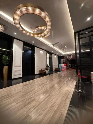 a lobby with a wooden floor and a chandelier at Chambers Luxury Studio KLCC by Velvet Aurum in Kuala Lumpur