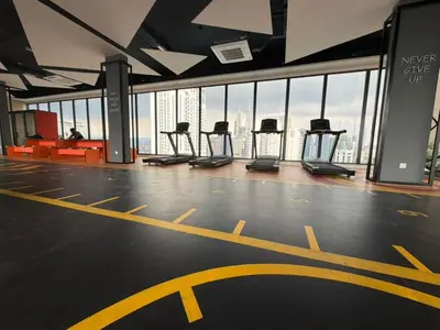 a gym with a row of treadmills in a building at Kuala Lumpur Majestic Apartment in Kuala Lumpur