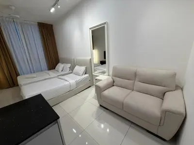 a living room with a couch and a mirror at Kuala Lumpur Majestic Apartment in Kuala Lumpur