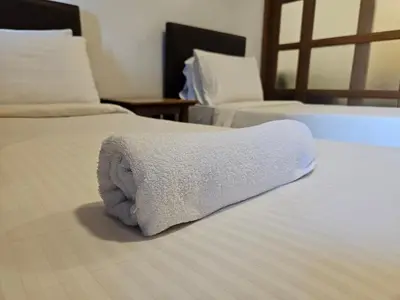 a towel on a bed in a hotel room at Menara PGRM Suites By VG Homes in Kuala Lumpur
