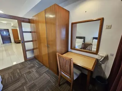 a room with a wooden table and a mirror at Menara PGRM Suites By VG Homes in Kuala Lumpur