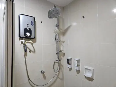 a bathroom with a shower with a camera on the wall at Menara PGRM Suites By VG Homes in Kuala Lumpur