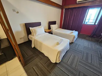 a room with two beds in a hotel room at Menara PGRM Suites By VG Homes in Kuala Lumpur