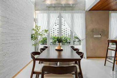 a dining room with a table and chairs and a window at Terasek Terrace with Private Pool in Kuala Lumpur