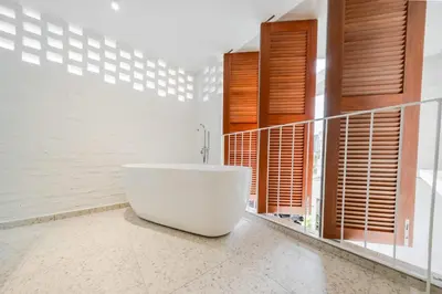 a white bath tub in a bathroom with windows at Terasek Terrace with Private Pool in Kuala Lumpur