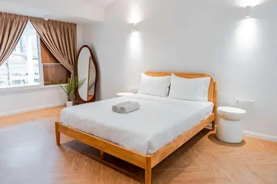a bedroom with a large bed with a clock on it at Terasek Terrace with Private Pool in Kuala Lumpur
