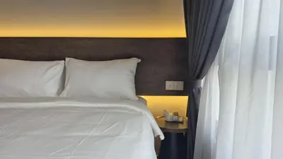 a bedroom with a white bed and a window at Agile Bukit Bintang TRX 4min MRT Studio Good View Netflix #031 in Kuala Lumpur