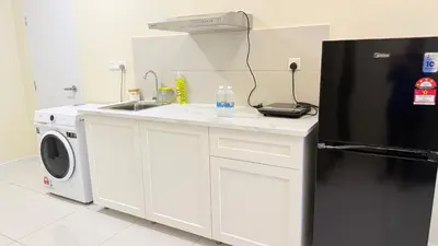 a kitchen with a sink and a refrigerator at majestic Resort Suites KLCC At Bukit bintang in Kuala Lumpur
