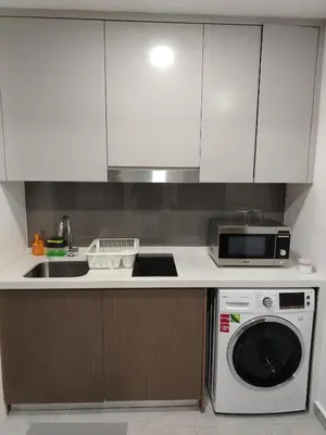 a kitchen with a microwave and a dishwasher at Agile Delima Homestay Premium Suites at TRX BUKIT BINTANG in Kuala Lumpur