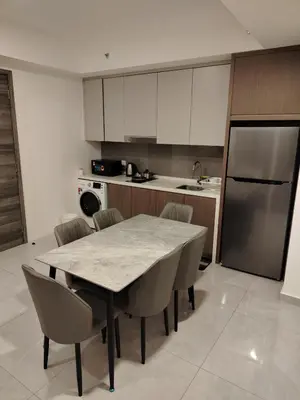 a kitchen with a table and chairs and a refrigerator at Agile Delima Homestay Premium Suites at TRX BUKIT BINTANG in Kuala Lumpur