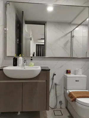 a bathroom with a sink and a toilet and a mirror at Agile Delima Homestay Premium Suites at TRX BUKIT BINTANG in Kuala Lumpur