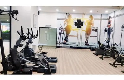 a gym with treadmills and exercise bikes in a room at Taragon Elite Residence in Kuala Lumpur