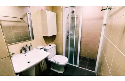 a bathroom with a toilet and a shower and a sink at Taragon Elite Residence in Kuala Lumpur