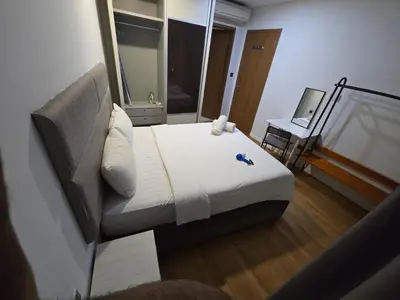 a small bedroom with a bed and a couch at Park view apartment klcc with city view in Kuala Lumpur