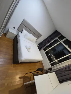 a bedroom with a bed and a large window at Park view apartment klcc with city view in Kuala Lumpur