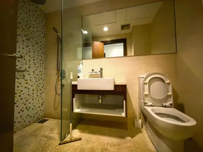 a bathroom with a toilet and a sink and a mirror at Park view apartment klcc with city view in Kuala Lumpur