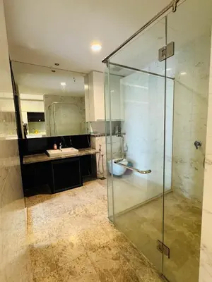 a bathroom with a glass shower and a sink at Platinum Suites KLCC by Home stay in Kuala Lumpur