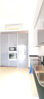 a white kitchen with a refrigerator and a sink at The Mews KLCC by Luxe Residence in Kuala Lumpur