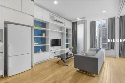 a living room with a tv and a chair and a desk at Elysian Sky Executive Platinum Suites KLCC in Kuala Lumpur