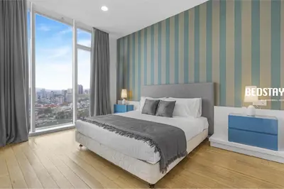a bedroom with a bed and a large window at Elysian Sky Executive Platinum Suites KLCC in Kuala Lumpur