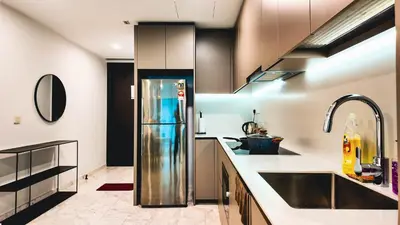 a kitchen with a stainless steel refrigerator in the middle at Eaton Residence KLCC - J Home in Kuala Lumpur
