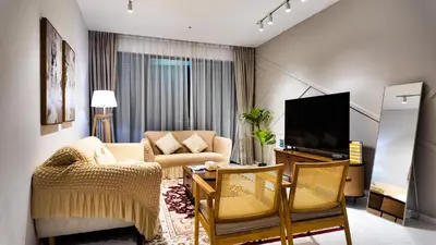 a living room with a couch and a tv at Eaton Residence KLCC - J Home in Kuala Lumpur