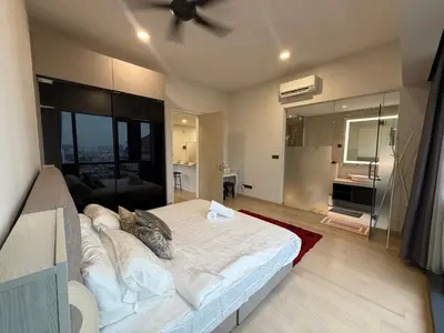 a bedroom with a large bed with a ceiling fan at Star Residences in Kuala Lumpur