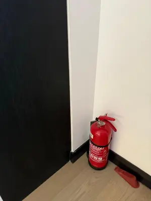 a red fire hydrant sitting in the corner of a room at Star Residences in Kuala Lumpur