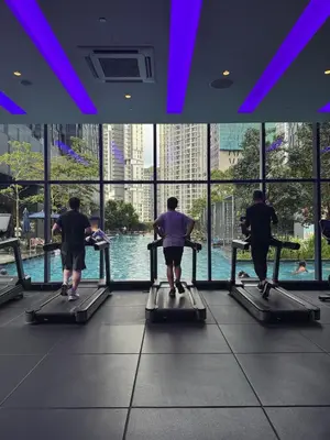 a group of people running on a treadmill in a gym at Star Residence KLCC By Nexus 72 in Kuala Lumpur