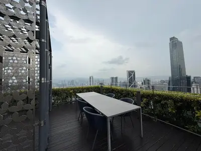 a table and chairs on the balcony of a building at Star Residence KLCC By Nexus 72 in Kuala Lumpur