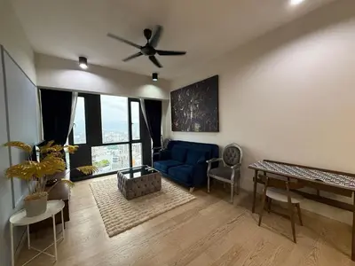 a living room with a blue couch and a ceiling fan at Star Residance by Nexus in Kuala Lumpur