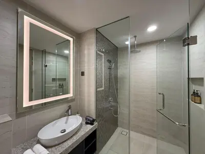 a bathroom with a sink and a glass shower at Star Residance by Nexus in Kuala Lumpur