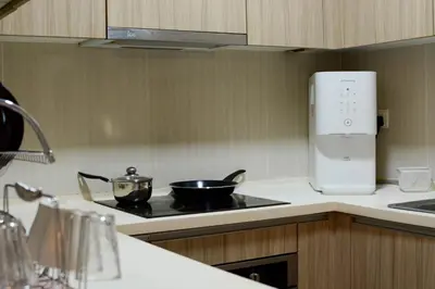a kitchen with a stove with two pots on it at The Elements Ampang by Greenhome in Kuala Lumpur