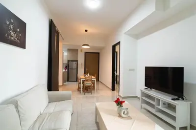 a living room with a white couch and a tv at The Elements Ampang by Greenhome in Kuala Lumpur