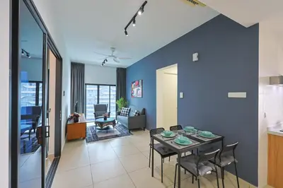 a dining room and living room with a table and chairs at Reizz Residence by Greenhome in Kuala Lumpur