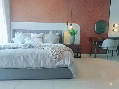 a bedroom with a large bed with a desk and a chair at Dorsett Residence by 