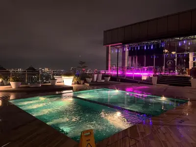 a pool on the roof of a building at night at Dorsett Residence by 