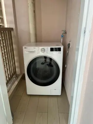 a washing machine sitting on the floor in a room at Dorsett Residence by 