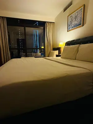 a large bed in a hotel room with a window at Times square by Willow Trip in Kuala Lumpur