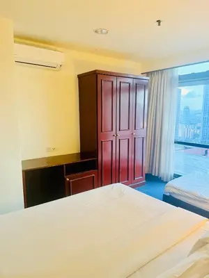 a hotel room with a bed and a window at Times square by Willow Trip in Kuala Lumpur