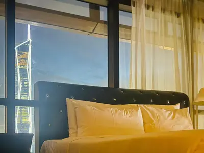 a bedroom with a bed and a large window at Times square by Willow Trip in Kuala Lumpur
